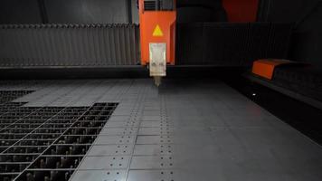 Industrial laser cutting machine. Laser cutting machine does industrial cutting. Making holes in metal sheet.
