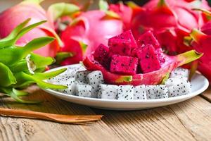 dragon fruit slice on white plate with pitahaya background , fresh white and red purple dragon fruit tropical in the asian thailand healthy fruit concept