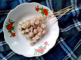Satay cilok or sticky steam meat ball on a plate. Indonesian culinary food photo