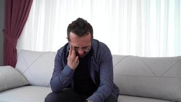 Man crying alone at home. Man crying from stress and unhappiness. Wiping tears. video