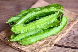 Winged Bean on sack background, Psophocarpus tetragonolobus - Green winged or Four angle beans photo