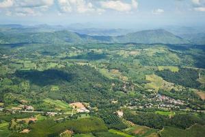 Top view village agriculture area view green field agricultural farm and  with road to the moutain photo