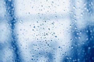 water drop glass background , nature water drop after rain , raindrops on glass window in the rainy season photo