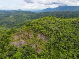Aerial view rock cliff forest trees background jungle nature green tree on the mountain top view , forest hill landscape scenery of river in southeast Asia tropical wild photo