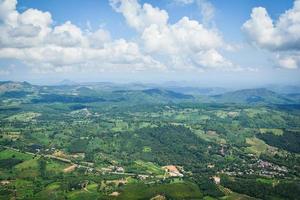 Top view village agriculture area view green field agricultural farm and  with road to the moutain photo