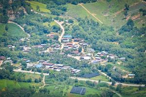 Top view village agriculture area view green field agricultural farm and  with road to the moutain photo