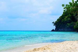 view of blue sea on the beach with sea rock wave on island photo