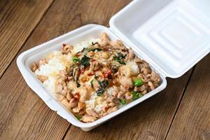lunch box foam , food box with rice stir fried chicken with holy basil takeaway food , street food - dangerous to health waste garbage foam food concept photo