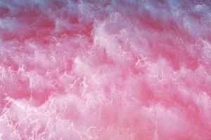 Defocus blurred pink water splash in the sea rippled water detail background. Water splash, water spray background. photo