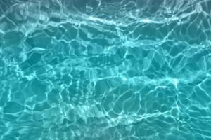 desenfoque de la acuarela azul borrosa en el fondo del detalle del agua ondulada de la piscina. salpicaduras de agua, fondo de pulverización de agua. foto