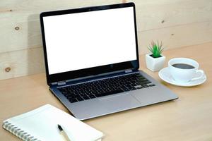 Coffee cup and laptop in office table photo