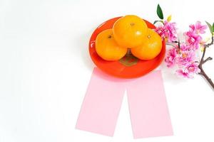 Flat lay Chinese New Year Background Mandarin Orange, Red Envelop and Flower on white background. photo