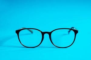 Glasses on a blue background photo