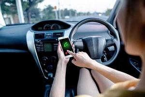 Close-up of woman talking on mobile phone while driving a car. photo