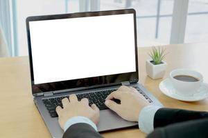 Businessman working on laptop computer with empty white screen photo