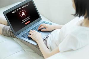 Hand tying laptop computer with password login on screen, cyber security concept photo