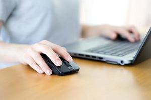 Image of female hands clicking computer mouse photo