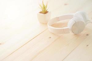 Headphones on wooden desk table photo