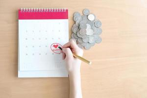 Hand writing in calendar plan and coins concept, Wedding photo