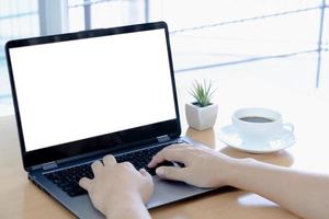 Businessman working on laptop computer with empty white screen photo