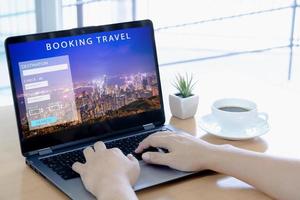 Man using a laptop for booking hotel online. Tour reservation photo