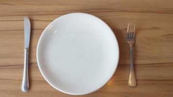 Empty plate with fork and knife photo