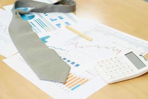Necktie Graphs Calculator and Pen. Finance Concept photo