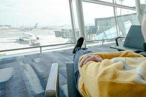 Young female passenger waiting for flight. photo