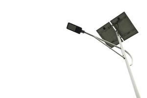 Street light pole with solar panel, eco-friendly alternative energy on white background. photo