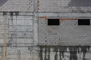 Background of gray and brown stone concrete wall made of blocks. Wall texture and background photo