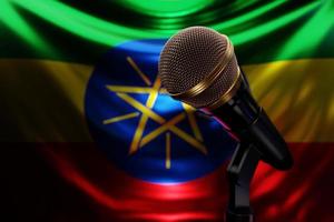 Microphone on the background of the National Flag of  Ethiopia, realistic 3d illustration. music award, karaoke, radio and recording studio sound equipment