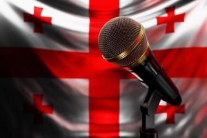 Microphone on the background of the National Flag of Georgia, realistic 3d illustration. music award, karaoke, radio and recording studio sound equipment photo