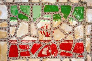 National flag of  Iran on stone  wall background. Flag  banner on  stone texture background. photo