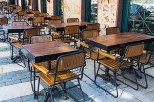 Atmospheric summer photography. Wooden cafe chairs  and  tables. Outdoor street cafe photo