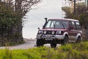 Side Turkey  February 20 2022    SUV Hyundai Galloper    is driving  on the street on a  summer day against the backdrop of a   park photo