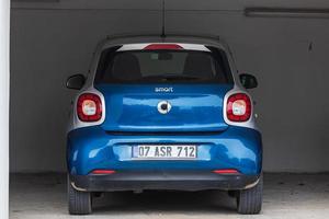 Side Turkey  February 23 , 2022   blue smart fortwo   is parked  on the street on a warm  autumn  day photo