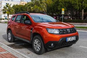 Side  Turkey  February  20, 2022  orange Renault Duster  is parked  on the street on a warm  day photo