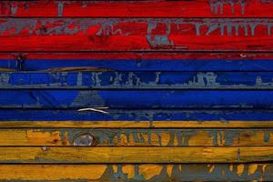 The national flag of Armenia is painted on uneven boards. Country symbol. photo