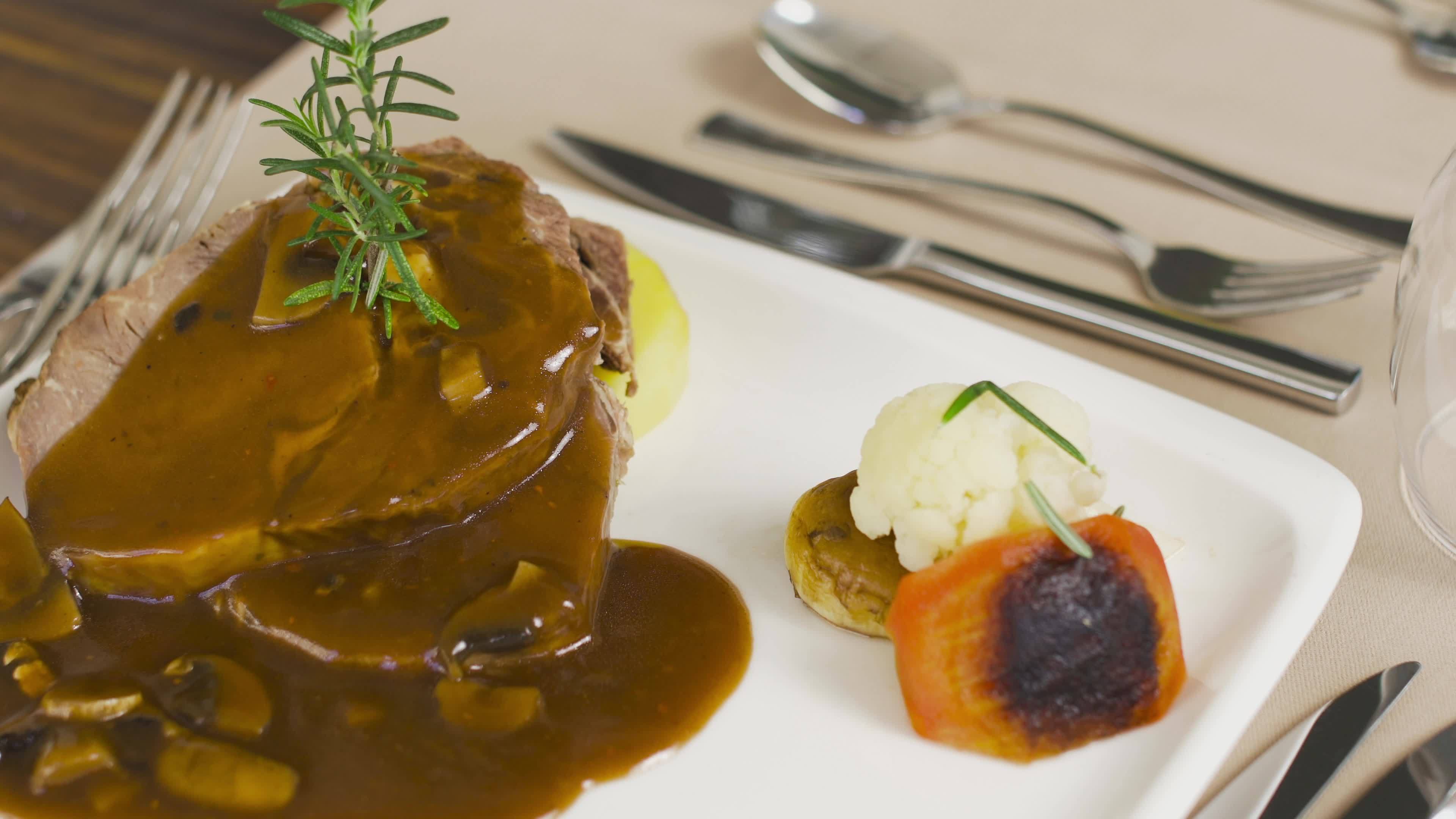 Presentation of meat dish with sauce. Steak meat dish with sauce