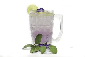 Purple Butterfly Pea Flower Water or Butterfly Pea Flower Tea with Honey and Lemon is a healthy herbal water with beta-carotene on a white background. photo