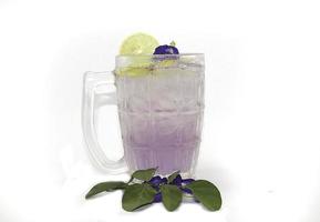 Purple Butterfly Pea Flower Water or Butterfly Pea Flower Tea with Honey and Lemon is a healthy herbal water with beta-carotene on a white background. photo