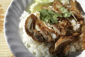 Fried chicken rice is a Thai food and popular with people around the world. Easy to eat with a little spicy taste. Reserve comes with dipping sauce and soup to keep. Don't tell me so I can stop. photo