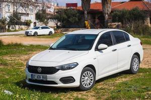 Side Turkey  February 28 2022  white   Fiat Egea   is parking  on the street on a  summer day photo