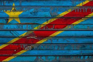 The national flag of Democratic Republic of the Congo is painted on uneven boards. Country symbol. photo