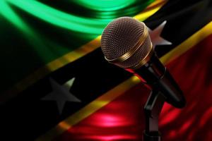 Microphone on the background of the National Flag of Saint Kitts and Nevis, realistic 3d illustration. music award, karaoke, radio and recording studio sound equipment photo