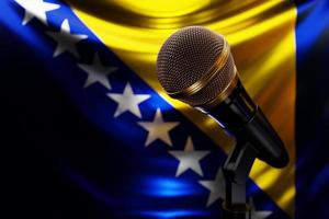 Microphone on the background of the National Flag of   Barbados, realistic 3d illustration. music award, karaoke, radio and recording studio sound equipment photo