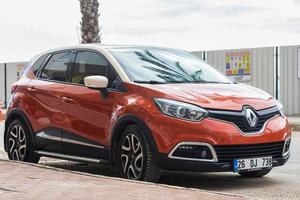 Side Turkey  February 20 2022  orange   Renault Kapture  is parked  on the street on a warm  day photo