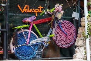 Antalya  Turkey February 20 2022 Close up decorative panel on a stone  wall consisting of  colorful bicycle decorated with knitting photo