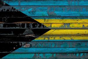 The national flag of Bahamas is painted on uneven boards. Country symbol. photo