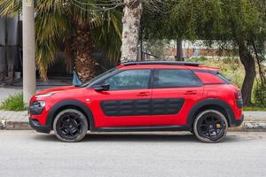 Side Turkey  February 23 , 2022  red Citroen C4 Cactus  is parking  on the street on a  summer day against the backdrop of a park photo